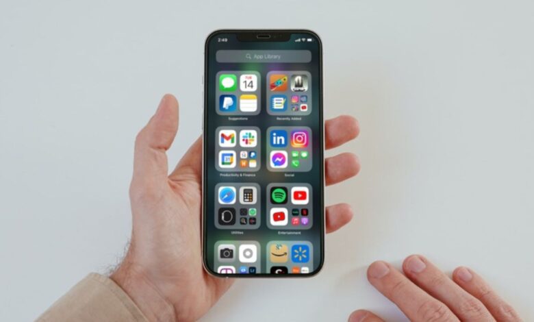 Image shows an iPhone with the App library on the screen