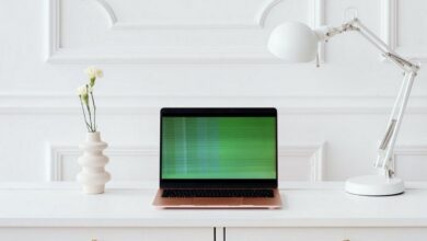 Green lines on a laptop sitting on a table