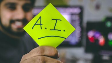 Man holding paper with A.I. written on it